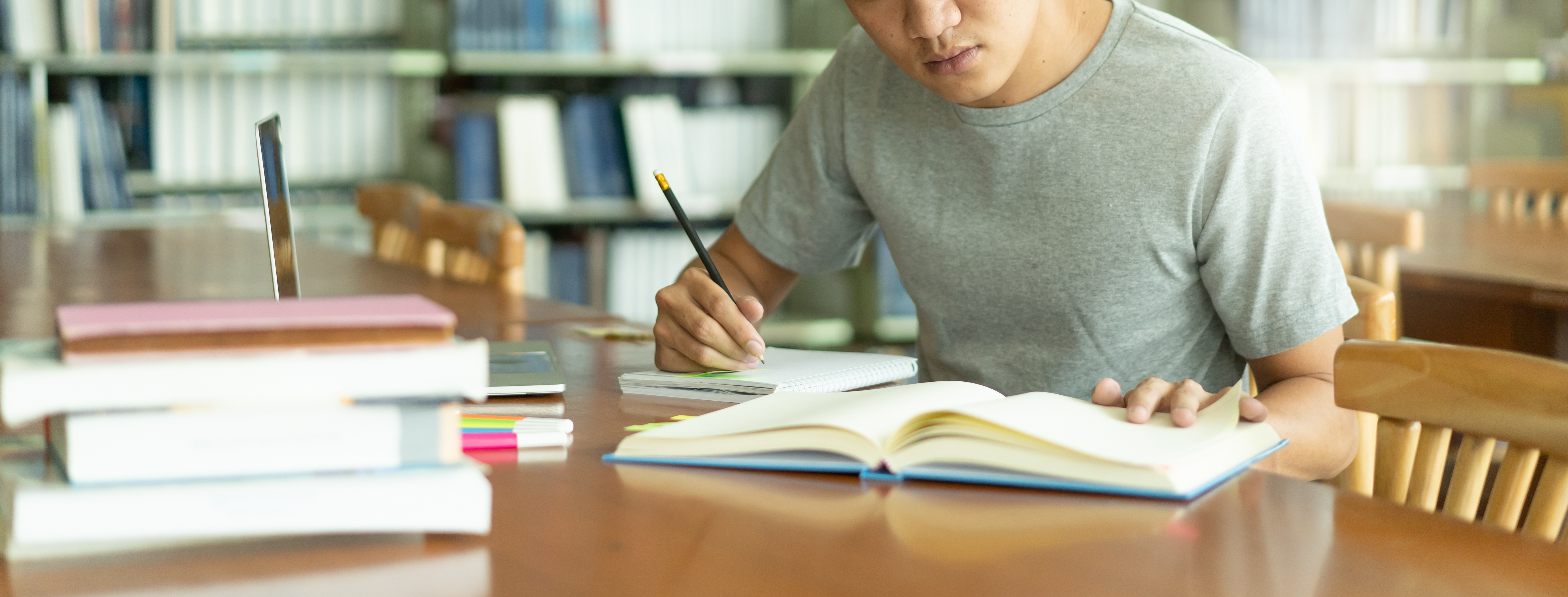 student studying with a book and notes